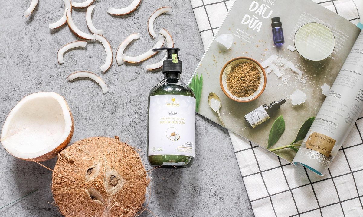 Shampoo bottles in a flatlay with coconut and haircare products