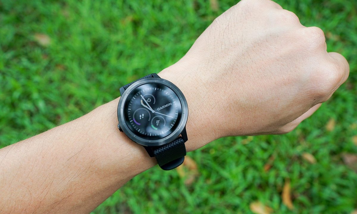 A modern smartwatch on a wrist showing fitness data
