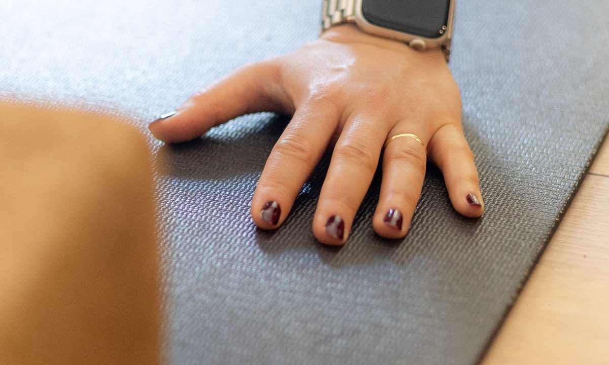A wrist fitness tracker showing workout data