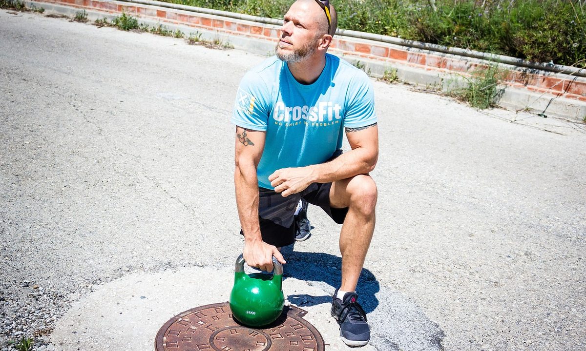 A cast iron kettlebell on a home gym floor