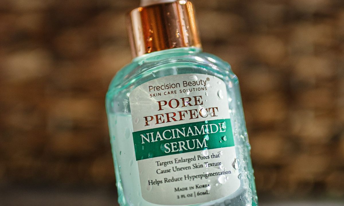 A niacinamide serum bottle on a skincare shelf