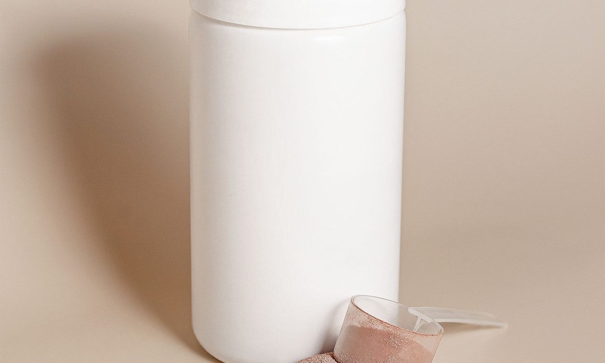 A whey protein powder container with a scoop