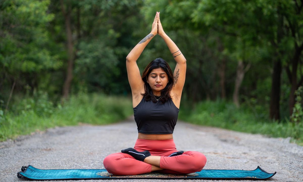 A thick cushioned yoga mat unrolled on a floor
